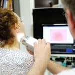examination of birthmarks and moles.the doctor examines the patient's mole