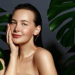 woman portrait with fresh green exotic tropical leaves