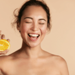 smiling-woman-with-radiant-face-skin-and-orange-portrait.
